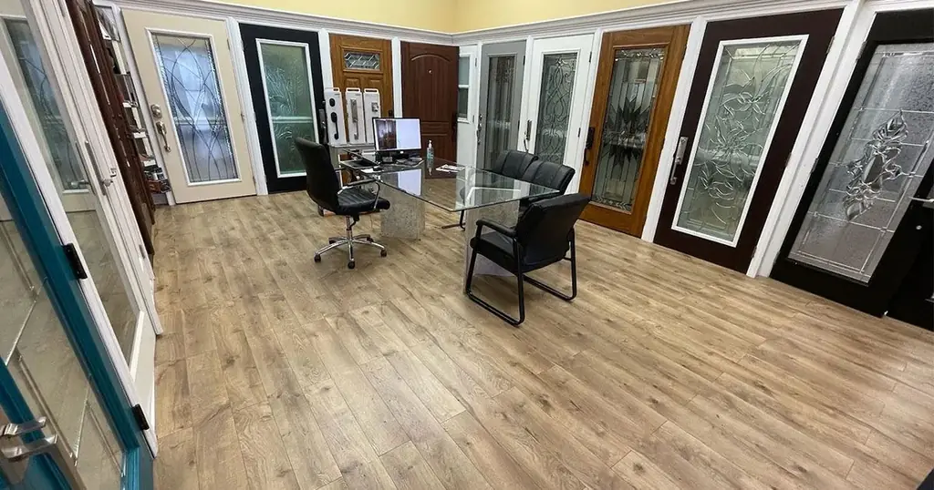 Inside the Strictly Doors showroom: door slabs and decorative glass samples along the walls